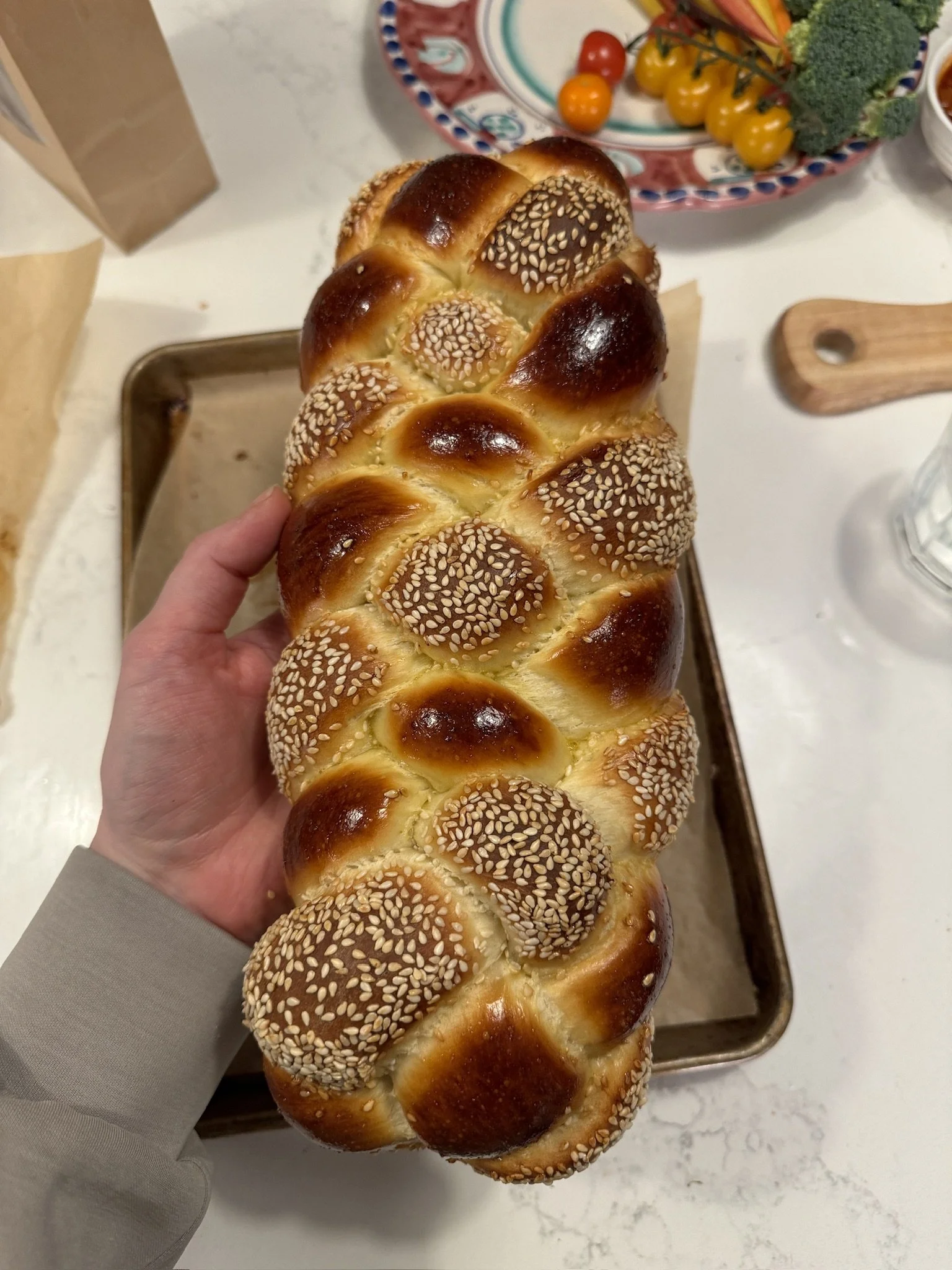 A six strand challah during prep for an event.