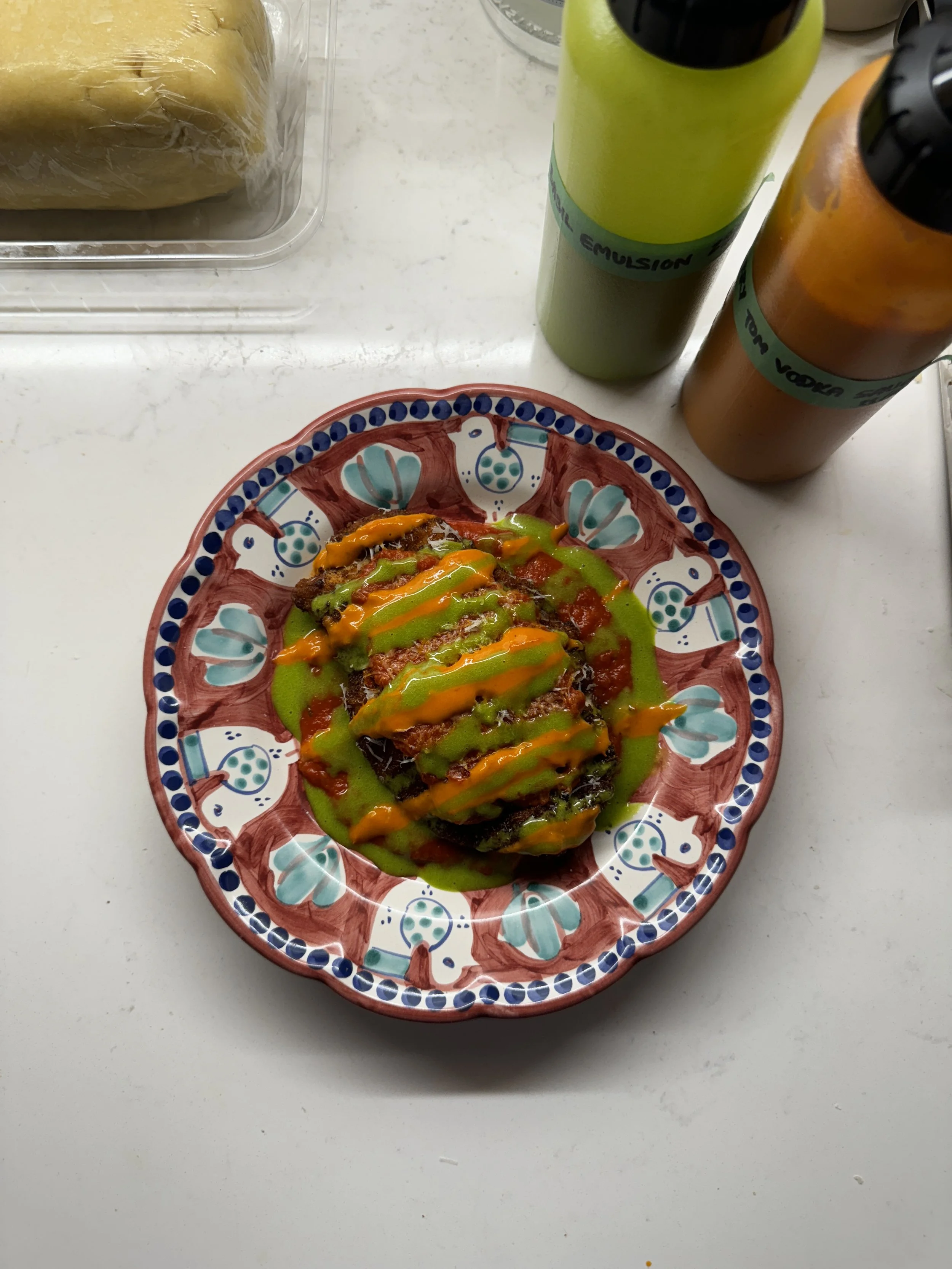 Chicken parmesan with basil emulsion and cherry tomato vodka sauce. 