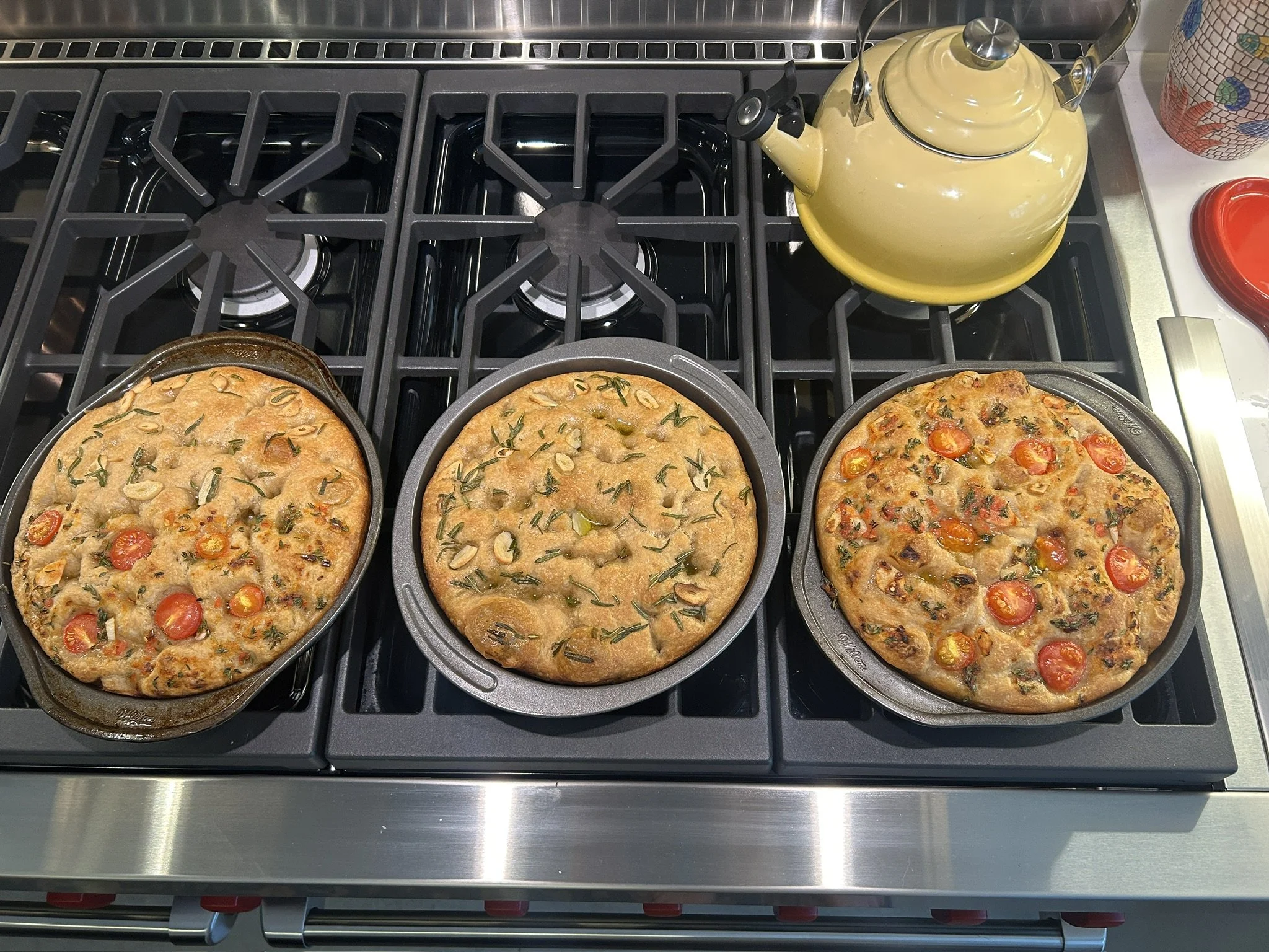 Three focaccias fresh out of the oven.