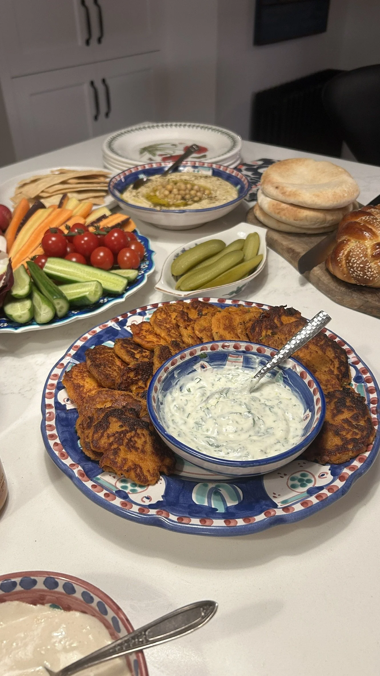 Sweet potato cakes with a cilantro yoghurt sauce on a middle eastern grazing table.