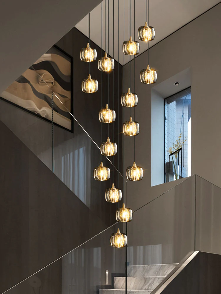 Modern staircase with hanging pendant lights in a contemporary interior.