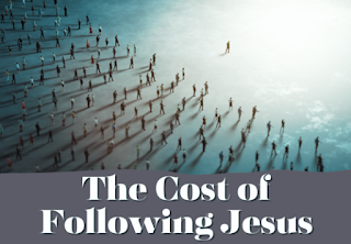 A large group of people standing on various sized floating platforms on water, with one person walking away from the group.