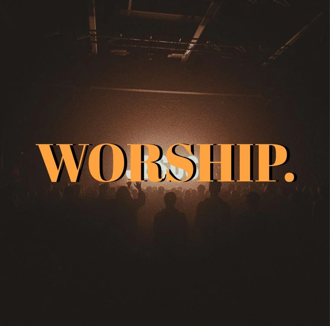 Audience attending a worship service or concert in a darkened space with stage lighting.