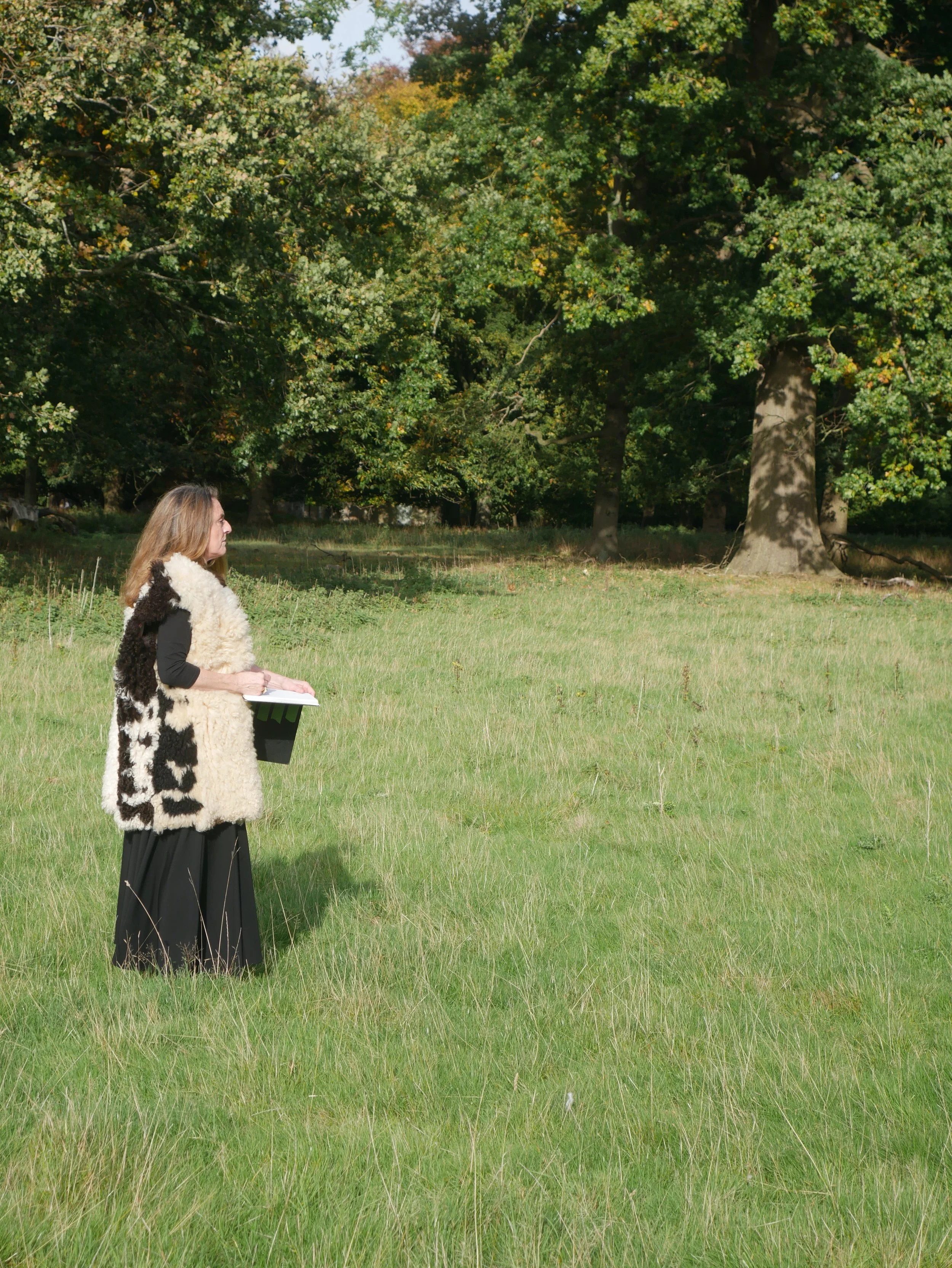 Portrait of artist Kate Giles sketching in the park at Holkham