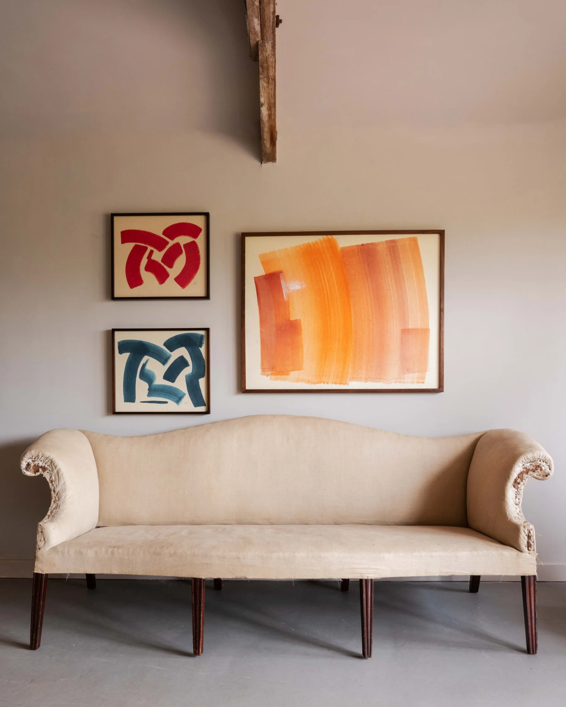 Harry Cory Wright colour field paintings hanging alongside an antique sofa