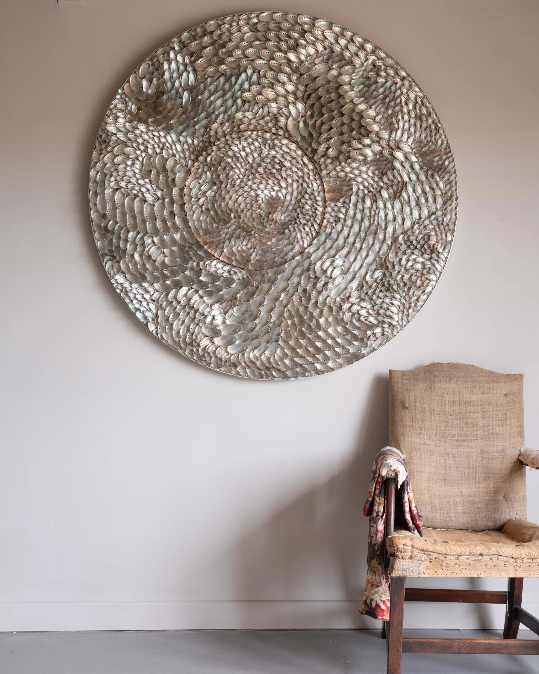 An original shell work by Blott Kerry Wilson with an antique chair