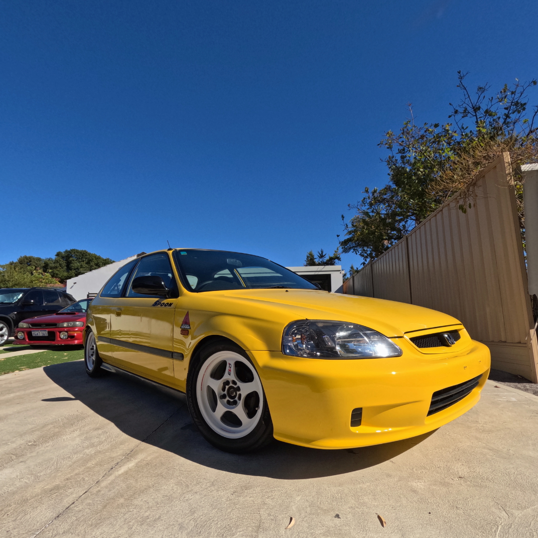 Restoration detailing on a rare Yellow EK Honda Civic in Perth. Exterior paint protection on a modified classic hatch, showcasing the factory DC2 Type R yellow finish.
