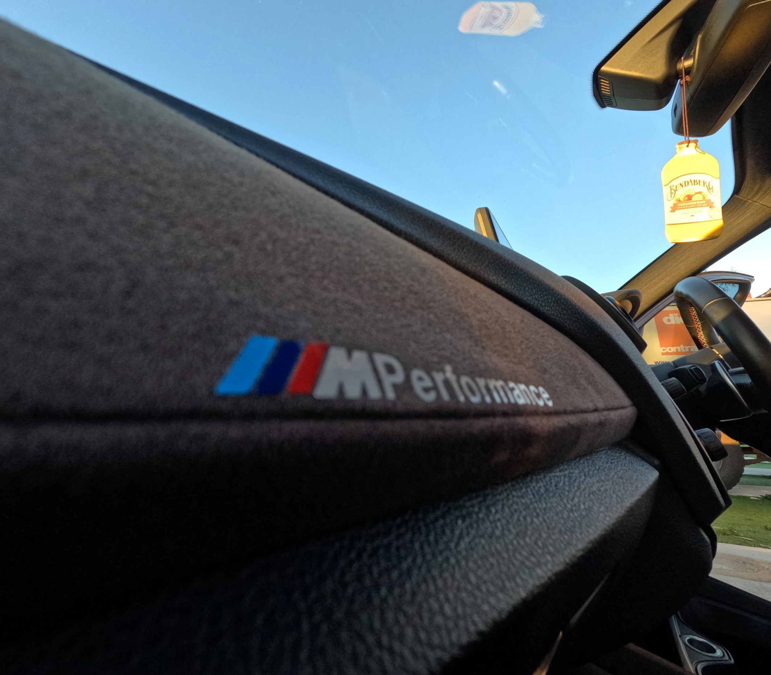 Professional interior detailing on a BMW M135i in Perth. Focus on alcantara dashboard cleaning and conditioning, showing a pristine M Performance finish.
