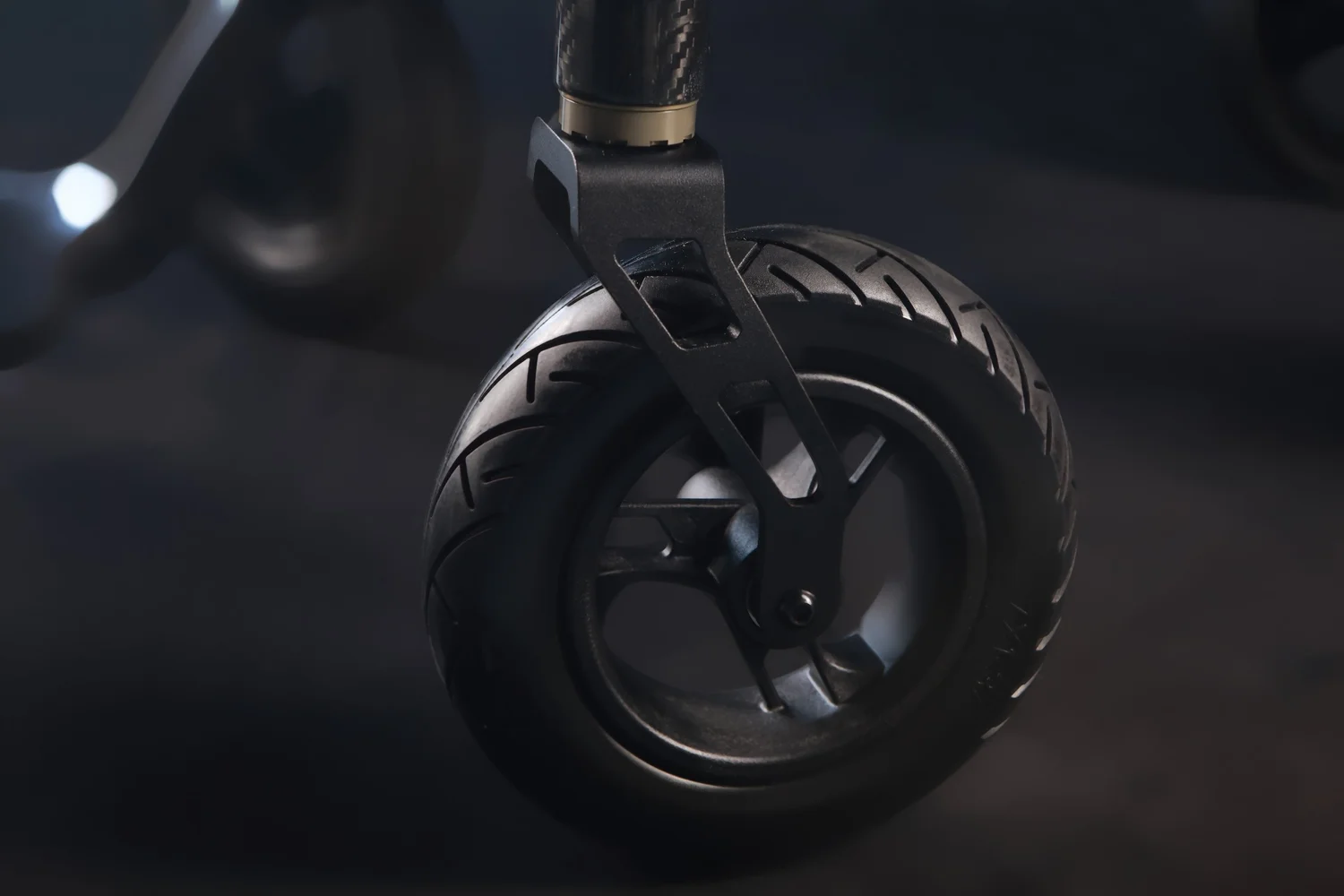Close detail of a carbon fork and wheel on an Elevate powerchair