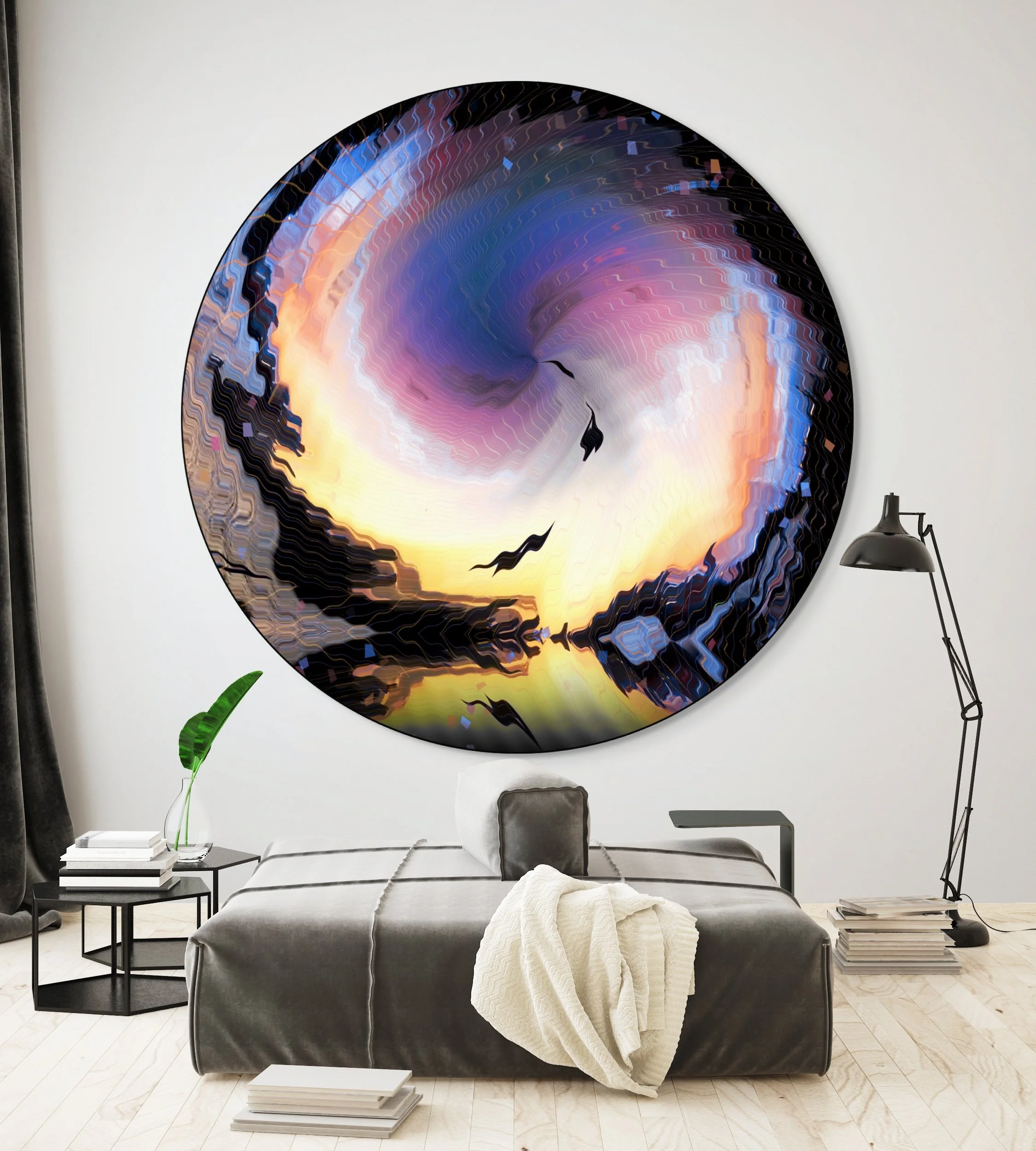 Modern bedroom with large circular abstract wall art featuring swirling colors of purple, yellow, orange, and black, with flying bird silhouettes. Bed with gray bedding and a white blanket, side table with books and a green plant, adjustable black fl