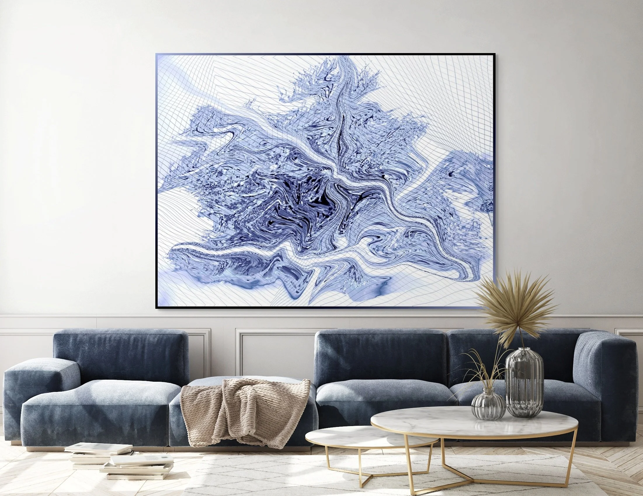 Living room with a large abstract blue and white painting on the wall, a navy blue sectional sofa with a beige throw blanket, and a white marble coffee table with vases, one containing dried plants.