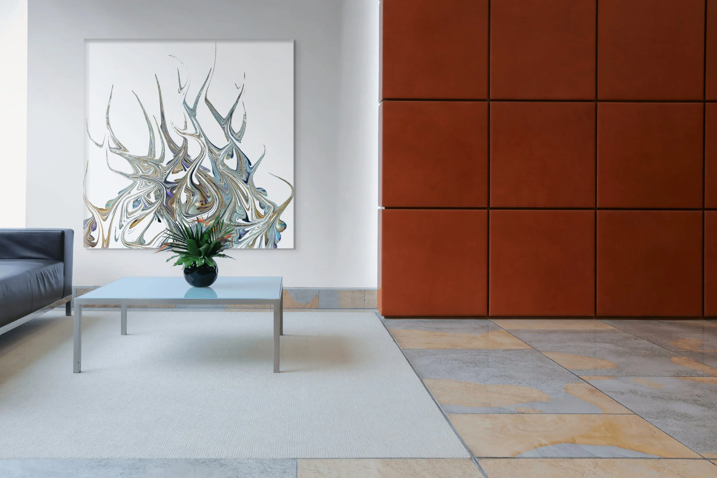 Modern interior lobby with abstract artwork on white wall, black sofa, glass-top coffee table with green plant, and reddish-brown panel wall, beige and gray tiled flooring.