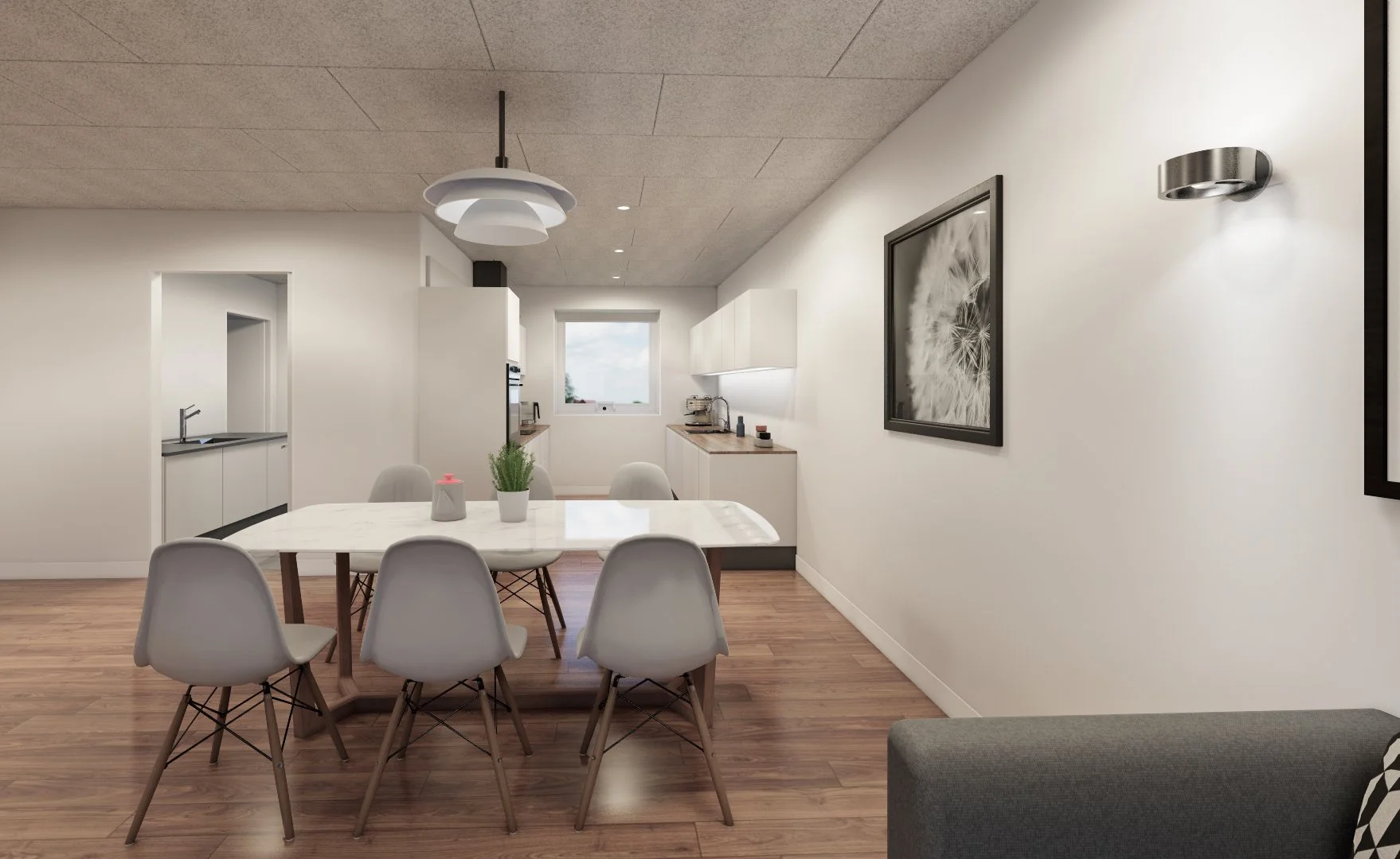 Moderne spise- og køkkenområde med spisebord, seks hvide stole, trægulv, hvid væg, væglampe og kunstprint