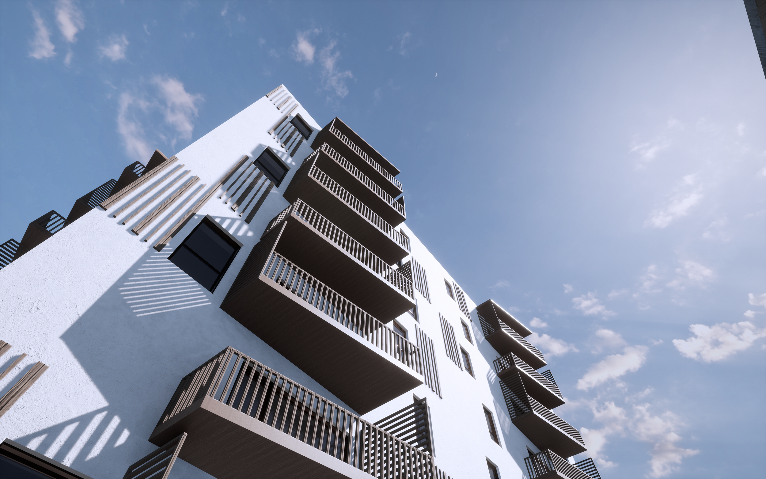 Moderne hvid boligbygning med flere altaner mod en blå himmel med få skyer.