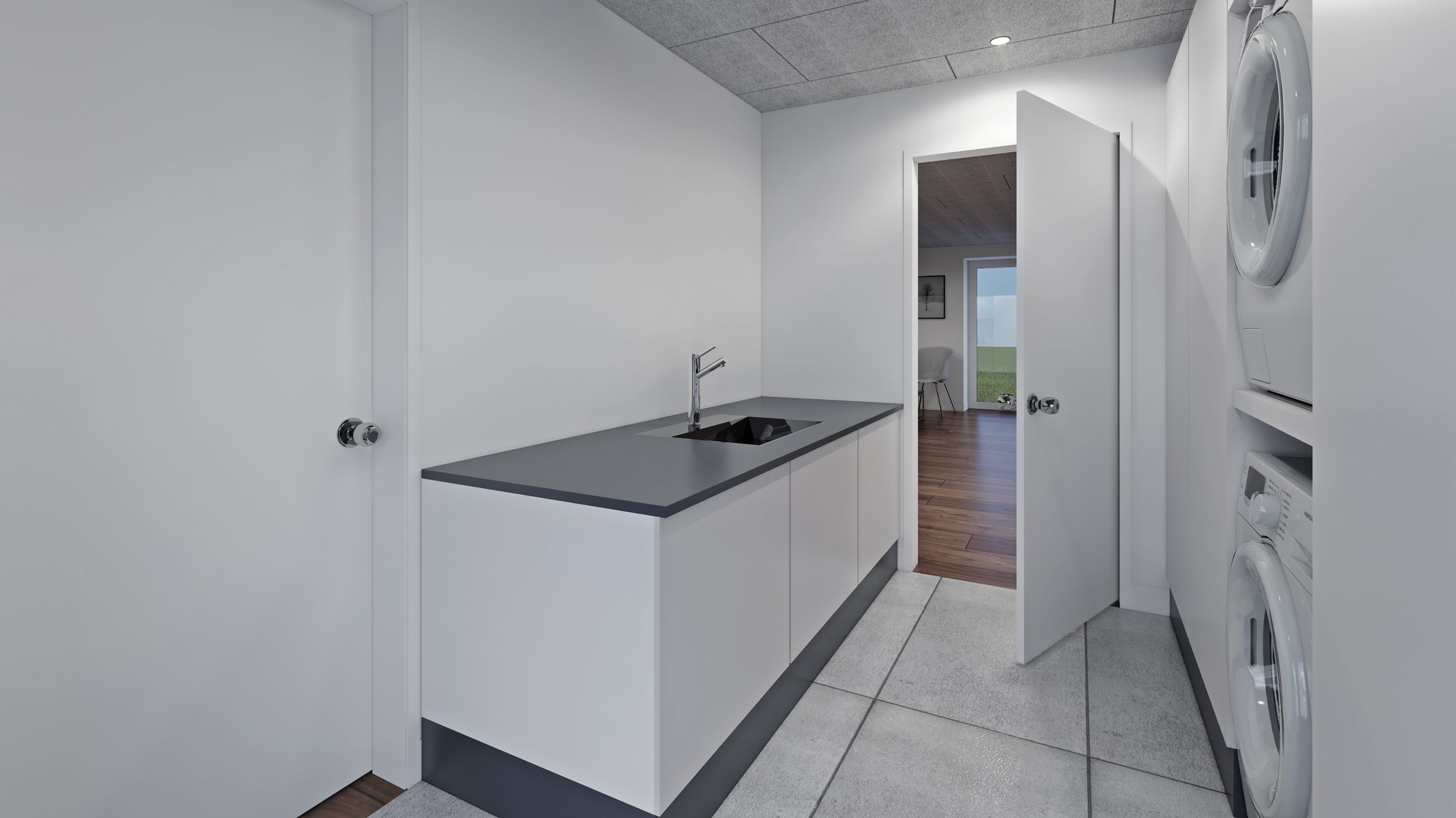 Lille vaskekælder med vaskemaskine og tørretumbler, hvid væg og sort granitbord.