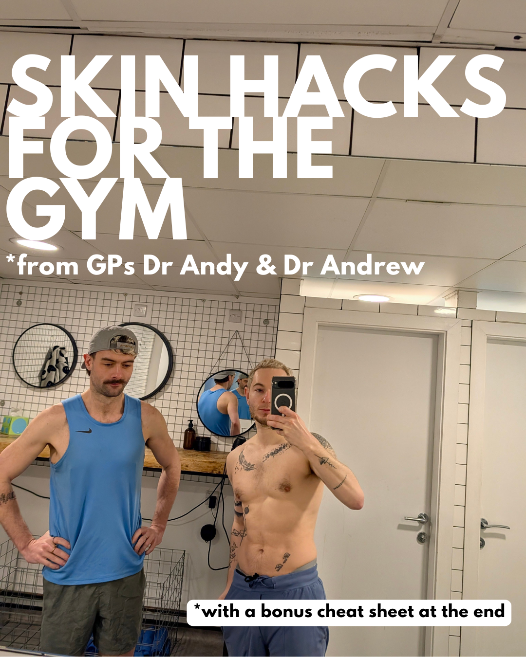 Two young men in a gym locker room. One is shirtless and taking a selfie in the mirror, the other is wearing a blue tank top and a gray hat. The background has white tiled walls, round mirrors, and various gym-related items.