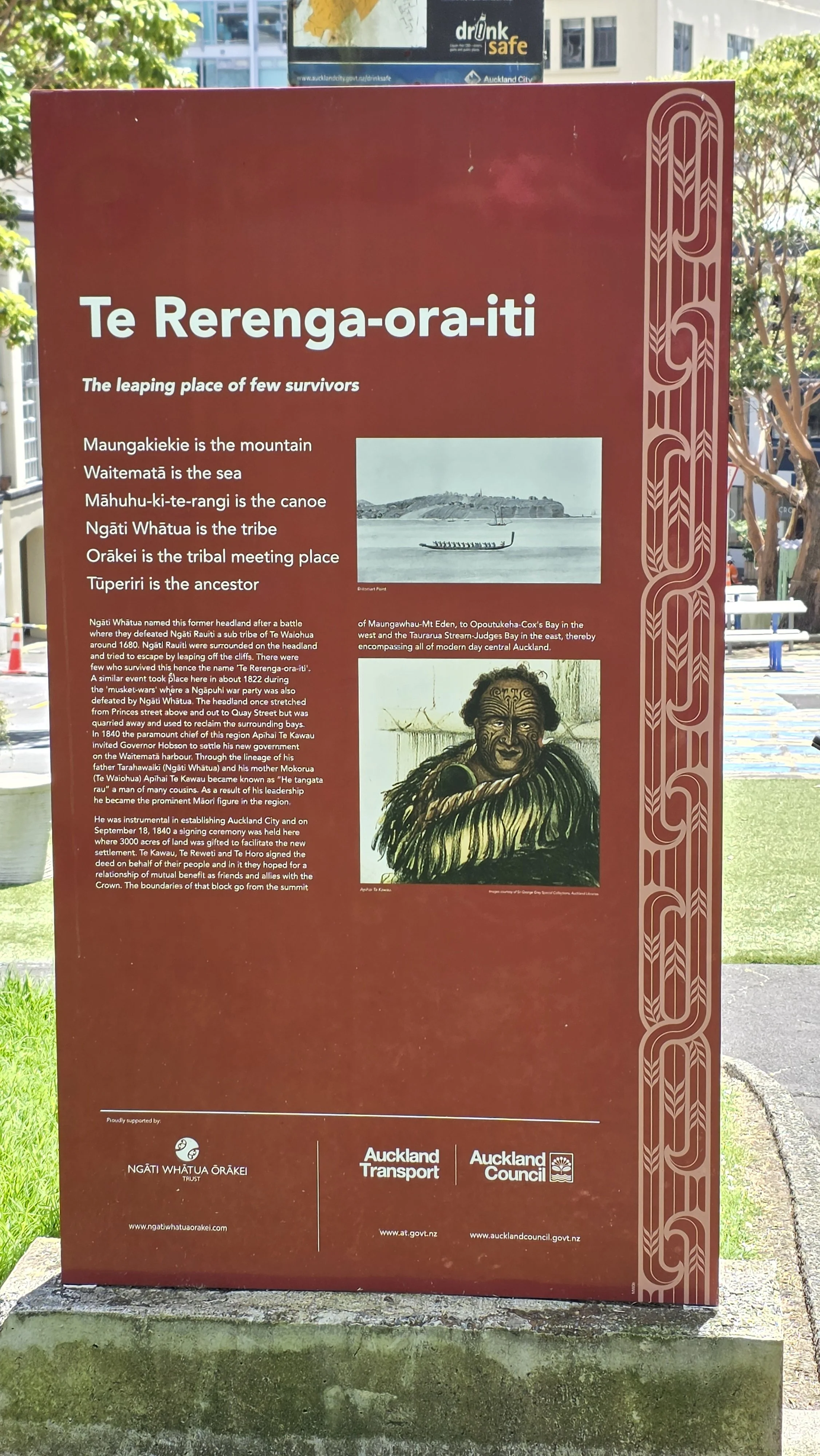 An informational outdoor poster titled 'Te Rerenga-ora-iti' with text explaining its significance, historical context, and connection to Maori culture, featuring two black and white photographs and a colored drawing of a Maori warrior.