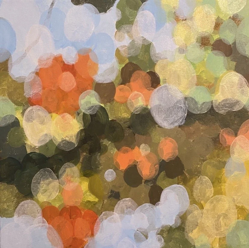 Abstract depiction of city street lights with various colored bokeh, including orange, yellow, green, and blue hues.