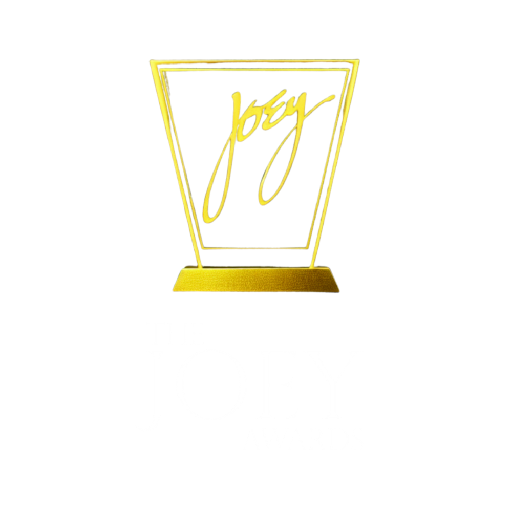 A neon sign with the name "Joey" written in yellow cursive inside a yellow-outlined trapezoid on a black background.