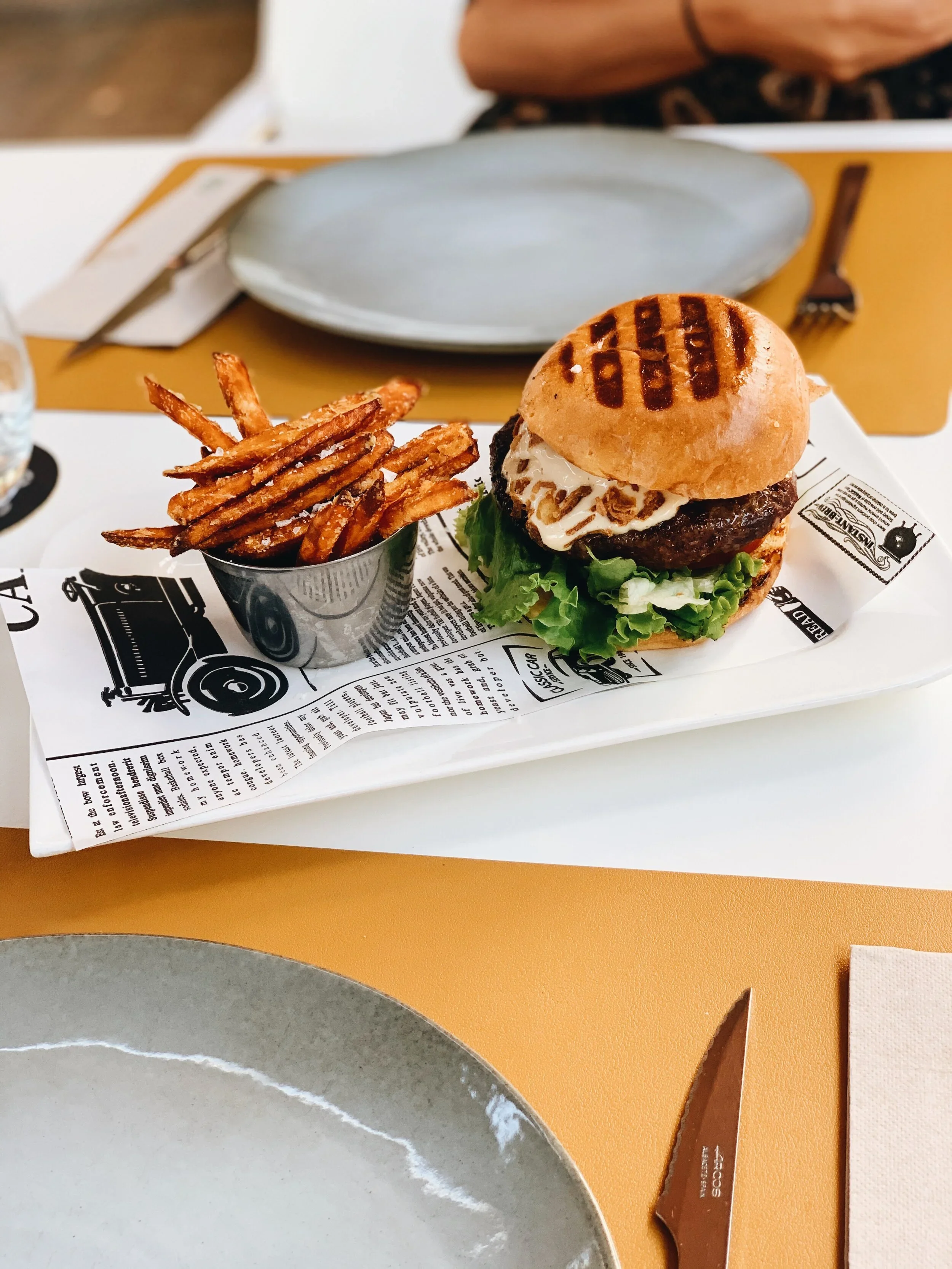 Burger and fries served at Mokelino, modern seaside restaurant in Los Cristianos.