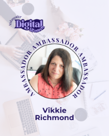 A woman with long brown hair wearing a pink sleeveless top, smiling, with a badge displaying her name 'Vikkie Richmond' and the title 'Digital Content'.