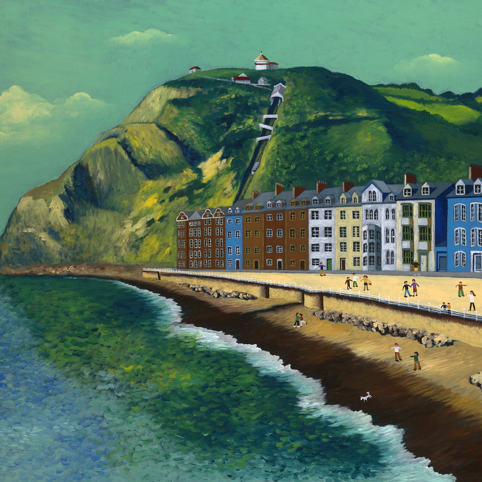 A colorful painting depicts a seaside scene with a row of multi-story houses along the shore, a grassy hillside with windmills and small buildings, a bridge over the water, and people walking along the pathway, under a partly cloudy sky.