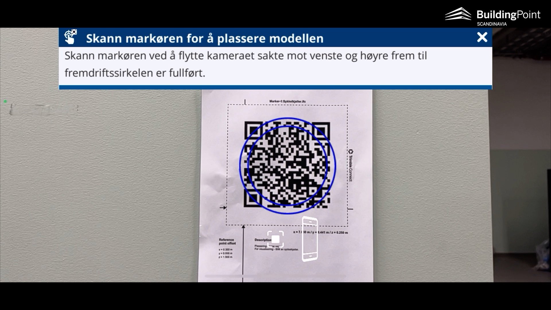 Scan the marker by rotating the phone around the marker and keeping the phone pointing at the marker