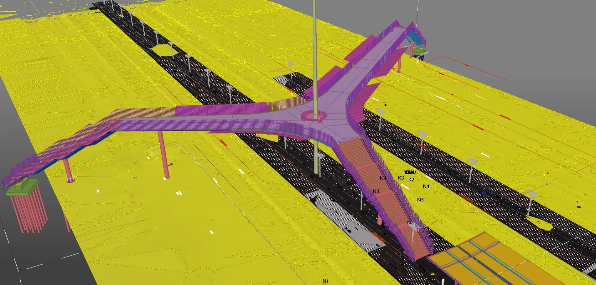 3D model of a complex pedestrian bridge design over a road with multiple lanes. The bridge has multiple pathways and is elevated with support pillars. The road and surroundings are color-coded for planning purposes.