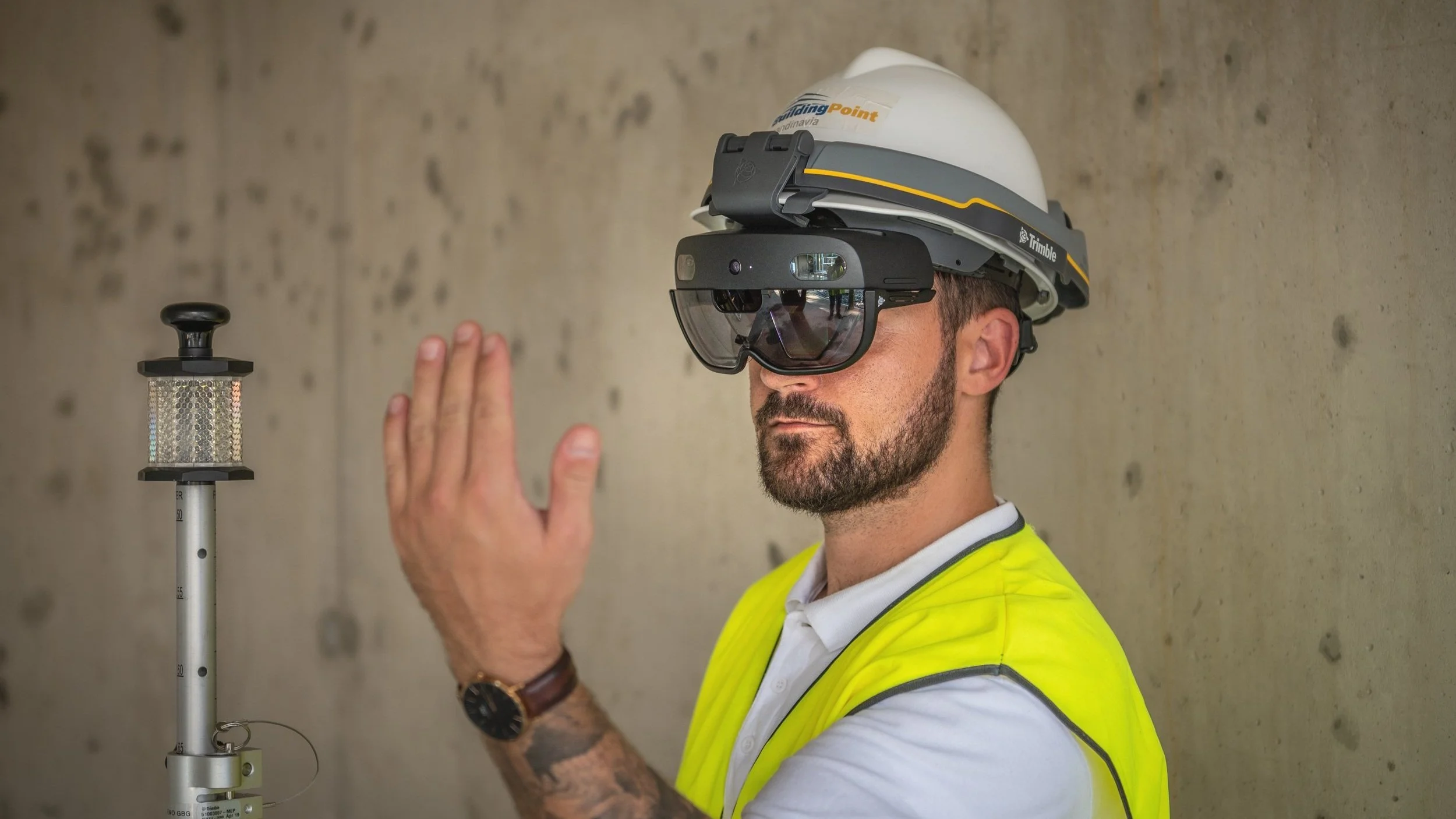 Construction worker with augmented reality headset and hard hat.