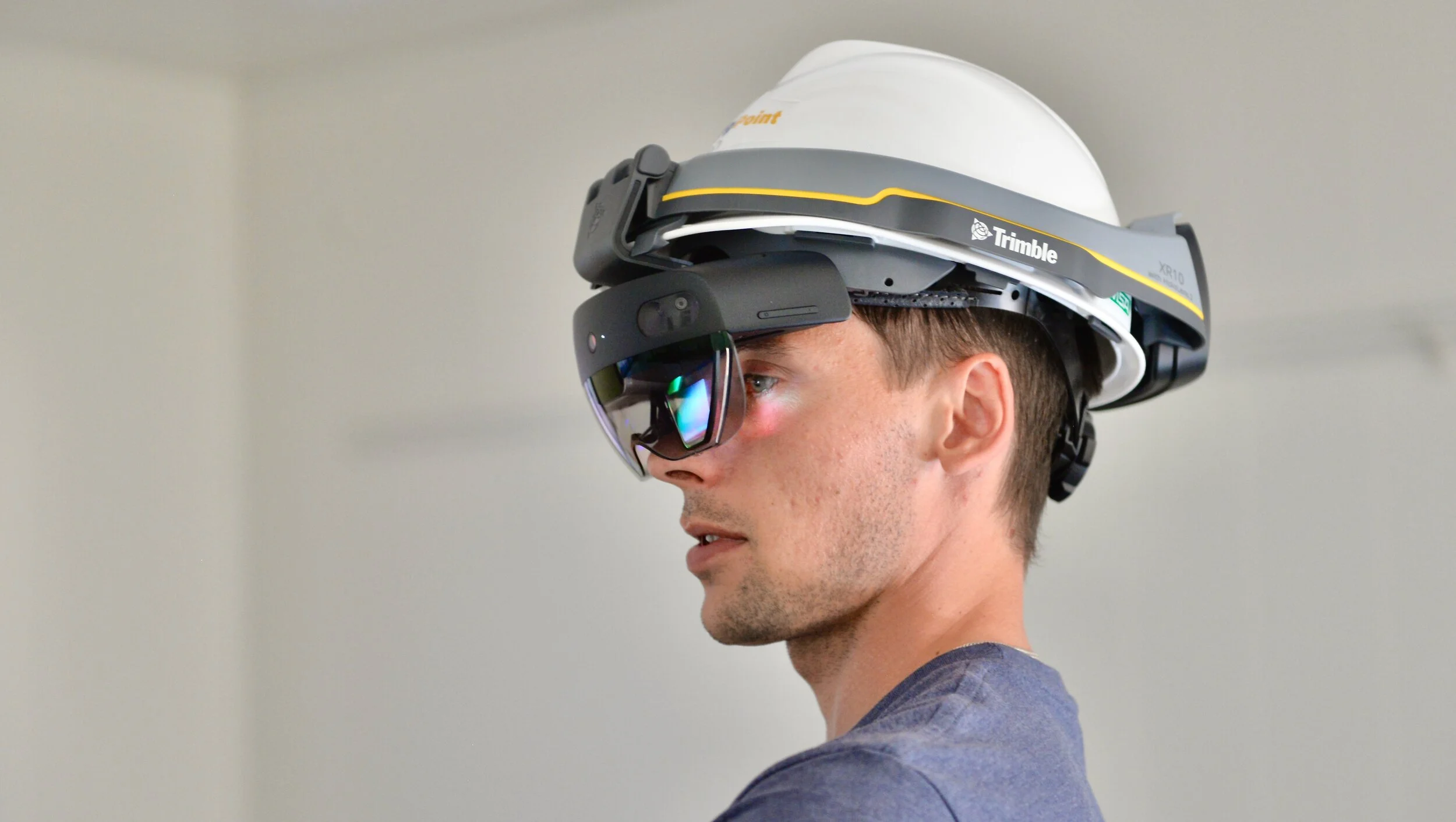 Person wearing augmented reality headset and hard hat