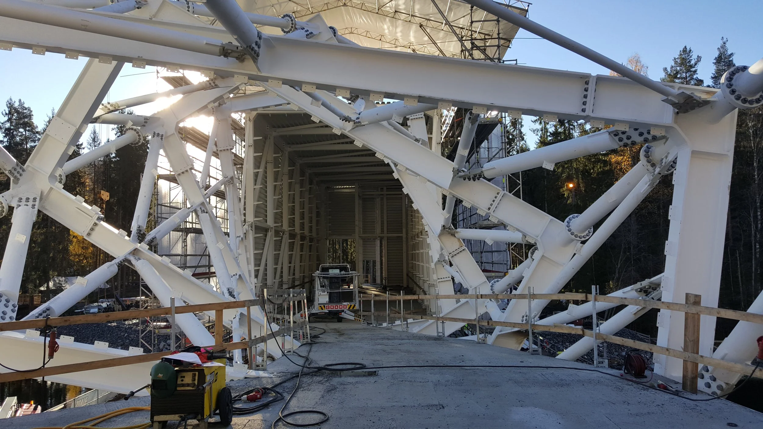 Modern bridge under construction with white steel framework