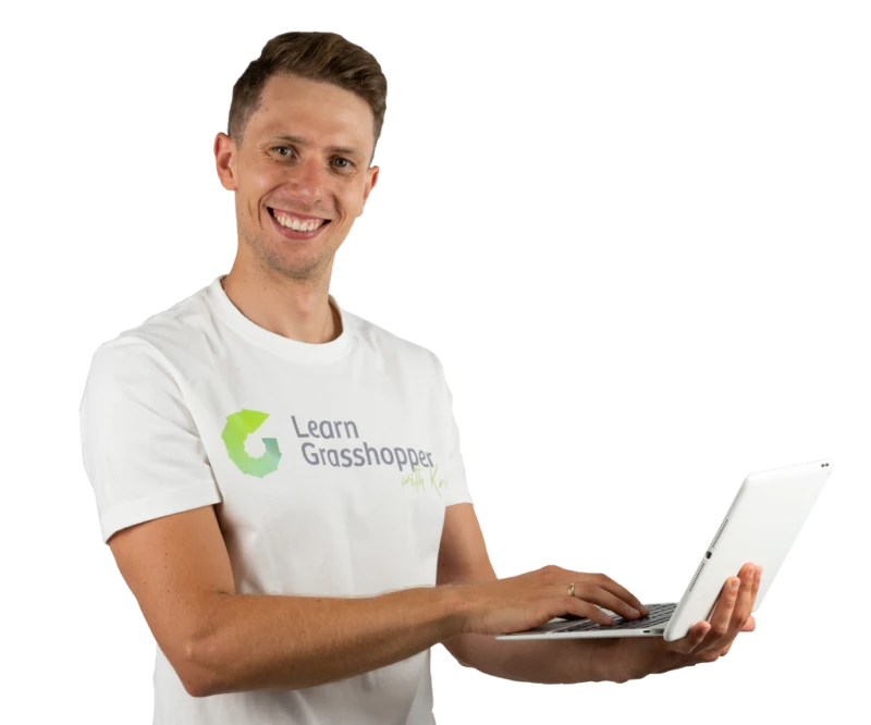 Man smiling, wearing a "Learn Grasshopper" t-shirt, using a laptop.