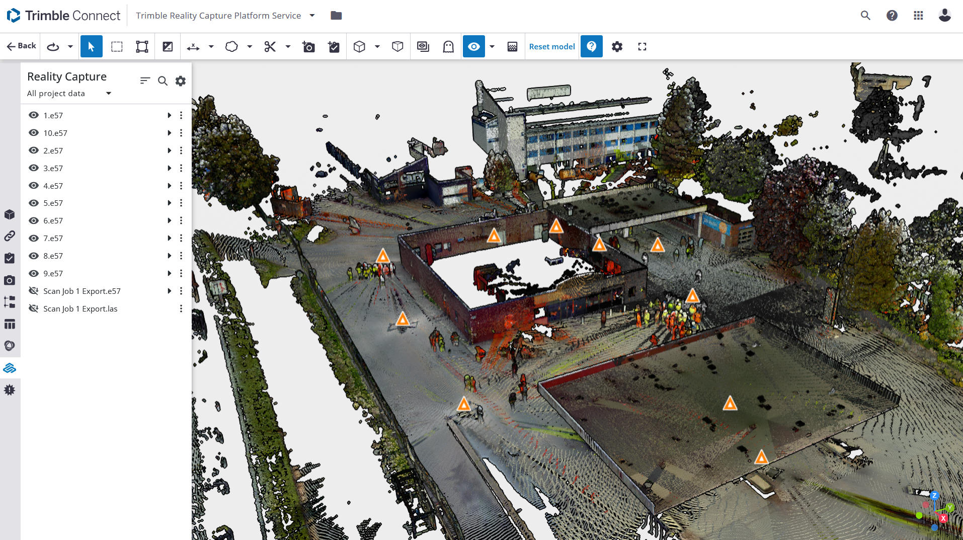 3D model rendered in Trimble Reality Capture showing a facility with multiple buildings, surrounding trees, and several highlighted points of interest with warning icons.