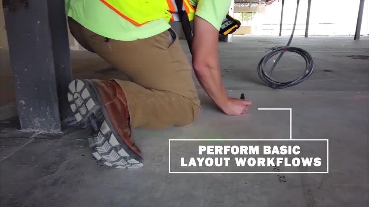 Construction worker using a marker on a concrete floor, wearing a safety vest, with the text 'Perform Basic Layout Workflows' overlayed.