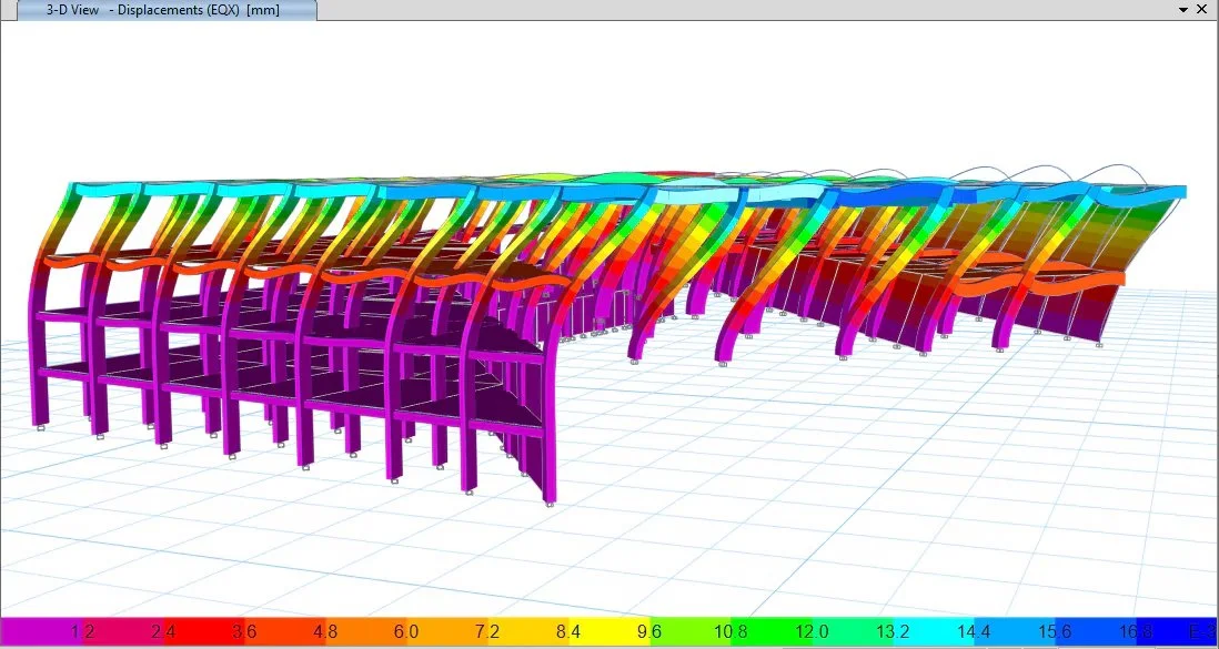 Color-coded 3D structural model of a row of chairs, showing displacement analysis with a color gradient from pink to blue indicating different levels of displacement.