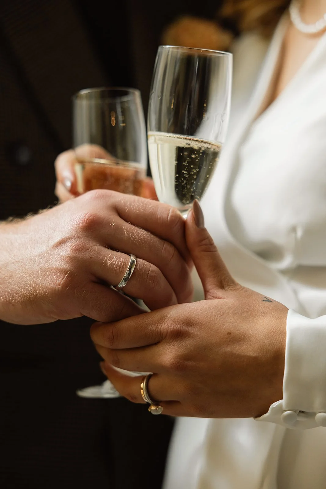 To personer holder hver sin glass med champagne i hånden.