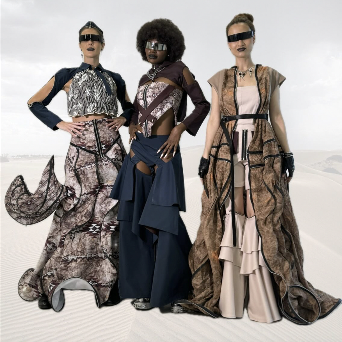 Three models standing side by side wearing garments from the Twenty9+ conceptual fashion brand project, developed in Dubai with desert-inspired colors and Emirati pattern influences.