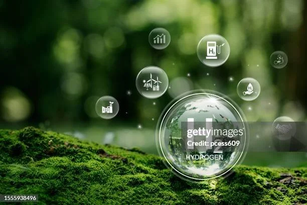 Digital illustration of a glass globe with the word 'HYDROGEN' on it, surrounded by icons representing renewable energy, hydrogen fuel, and environmental sustainability, set against a green forest background.