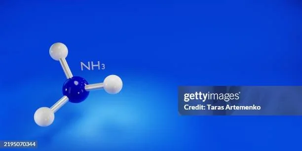 Model of an ammonia molecule with a blue nitrogen atom and three white hydrogen atoms connected by bonds on a blue background.