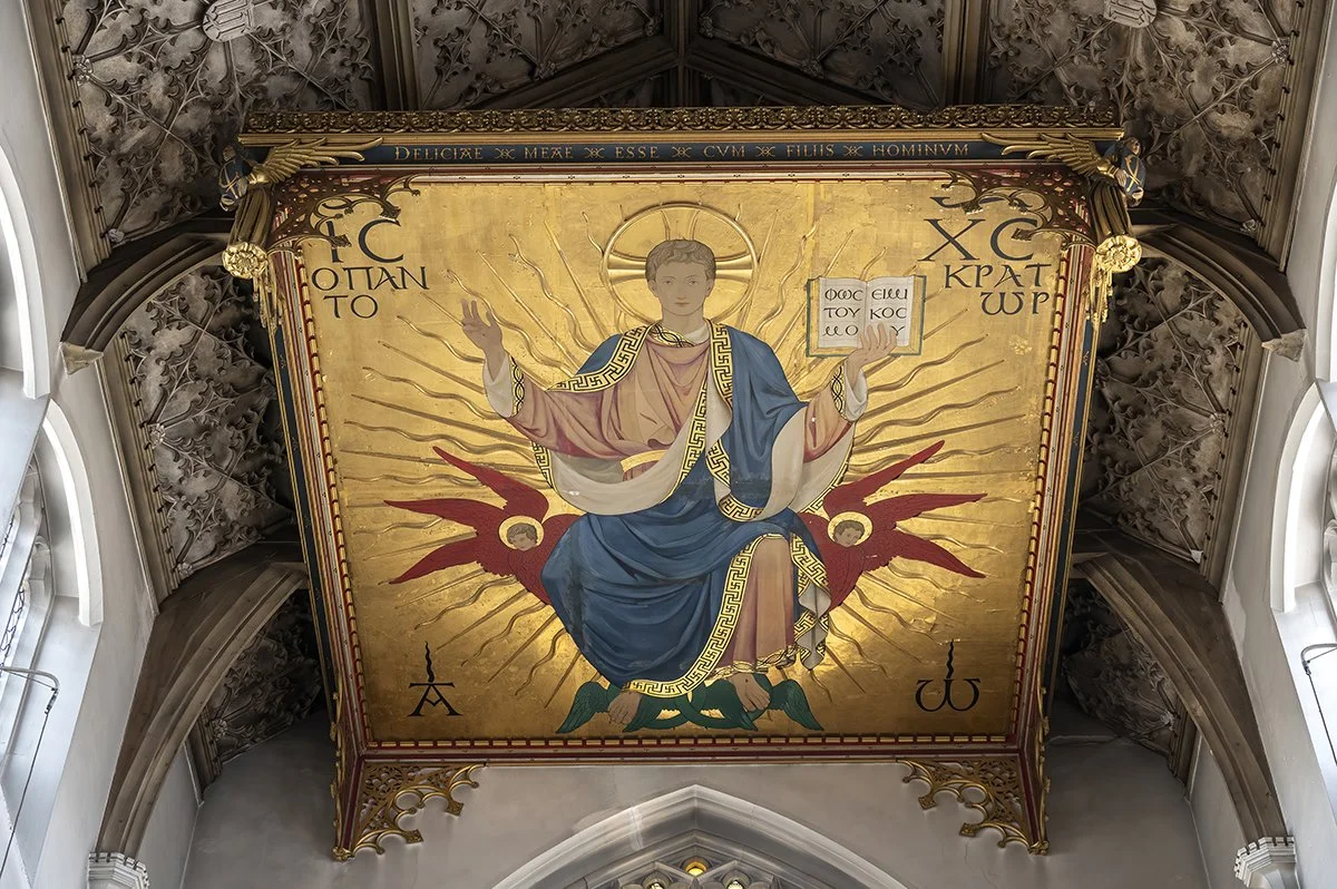 Religious iconography depicting Jesus Christ seated on a globe, surrounded by a luminous golden background and angelic figures, with Greek inscriptions.