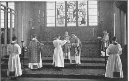 A group of priests and altar servers performing a religious ceremony in a church with stained glass windows.