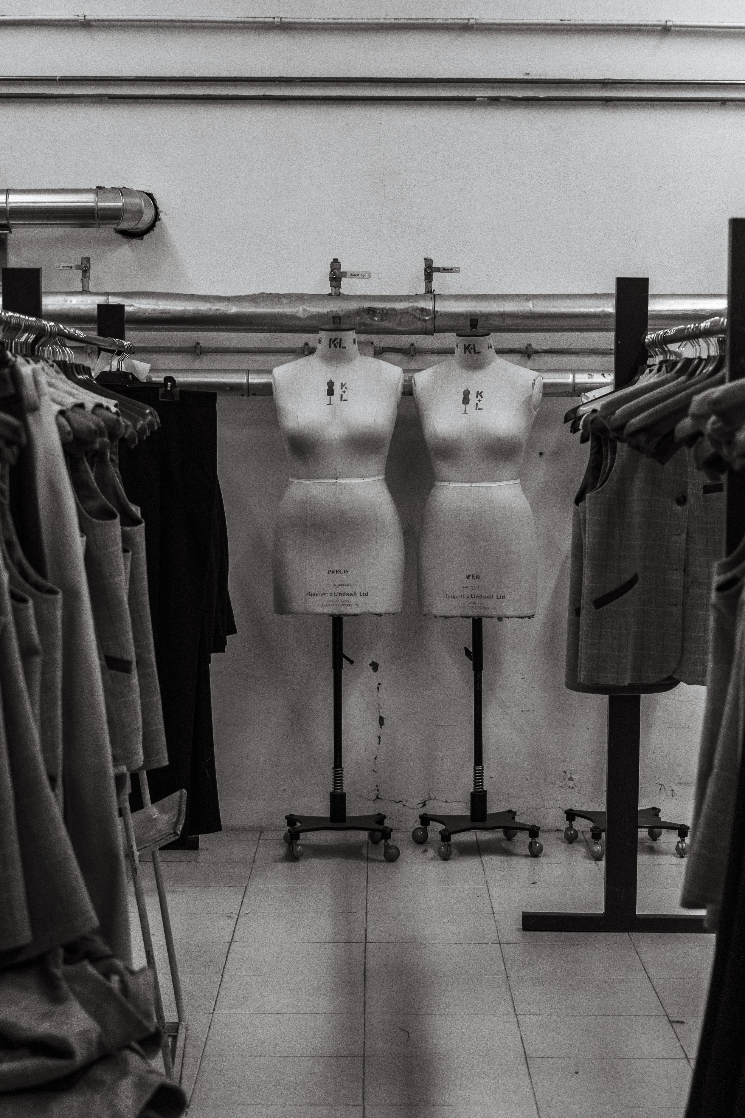 Fashion atelier with dress forms and garments in development.