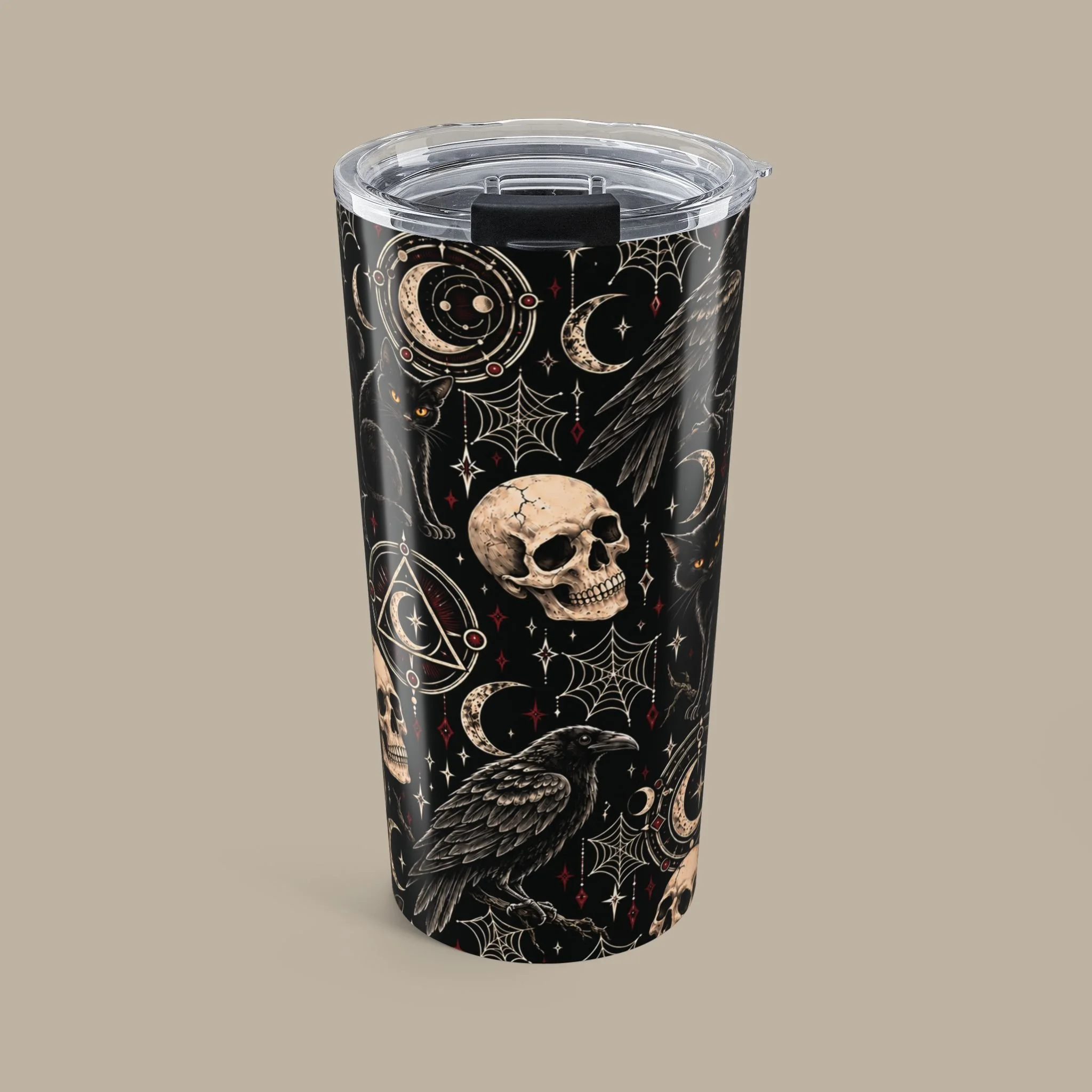 Front of the Gothic Magic 20oz tumbler, with ivory skulls, ravens and crescent moons on a dark wrap.