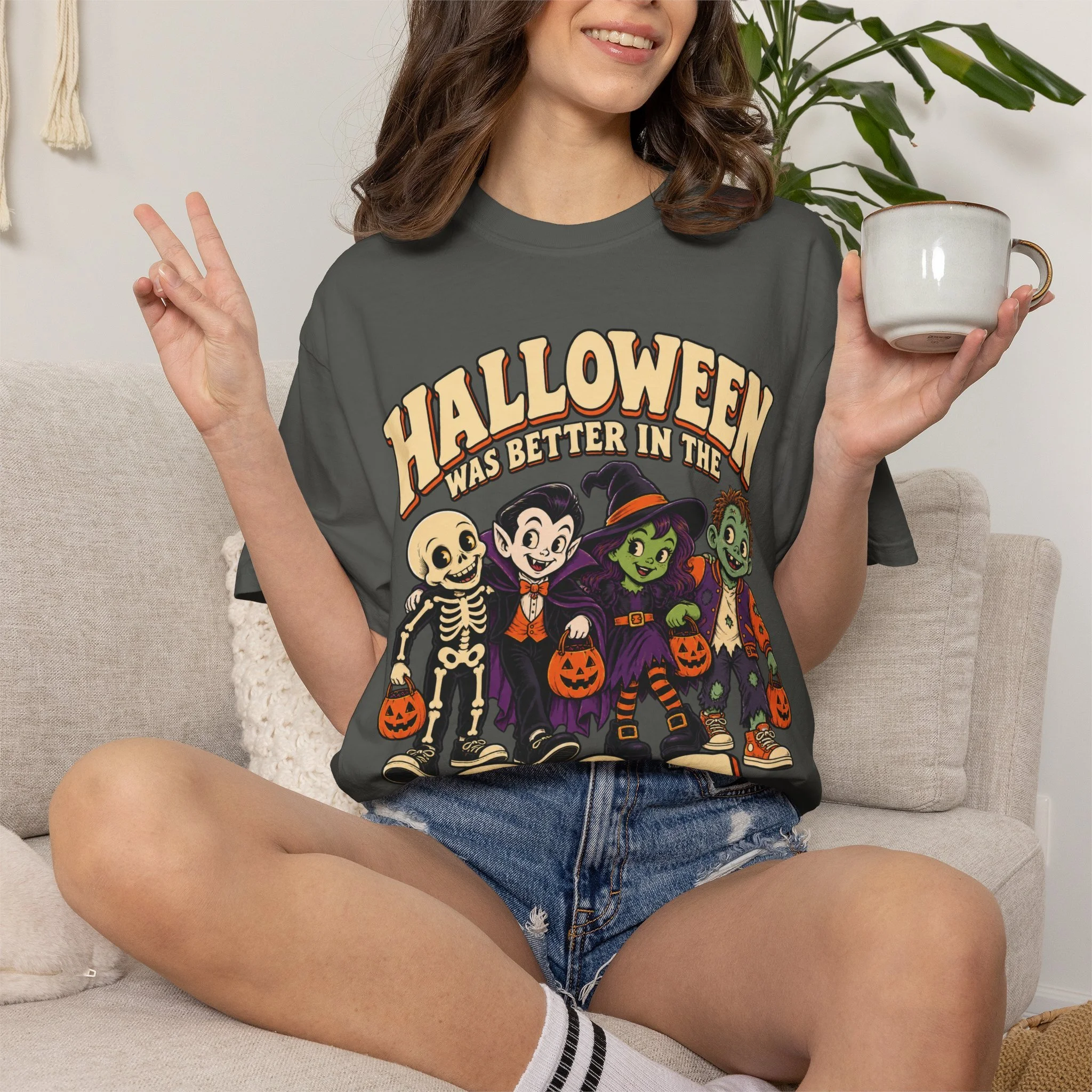 Seated model wearing Pepper retro Halloween tee, front view