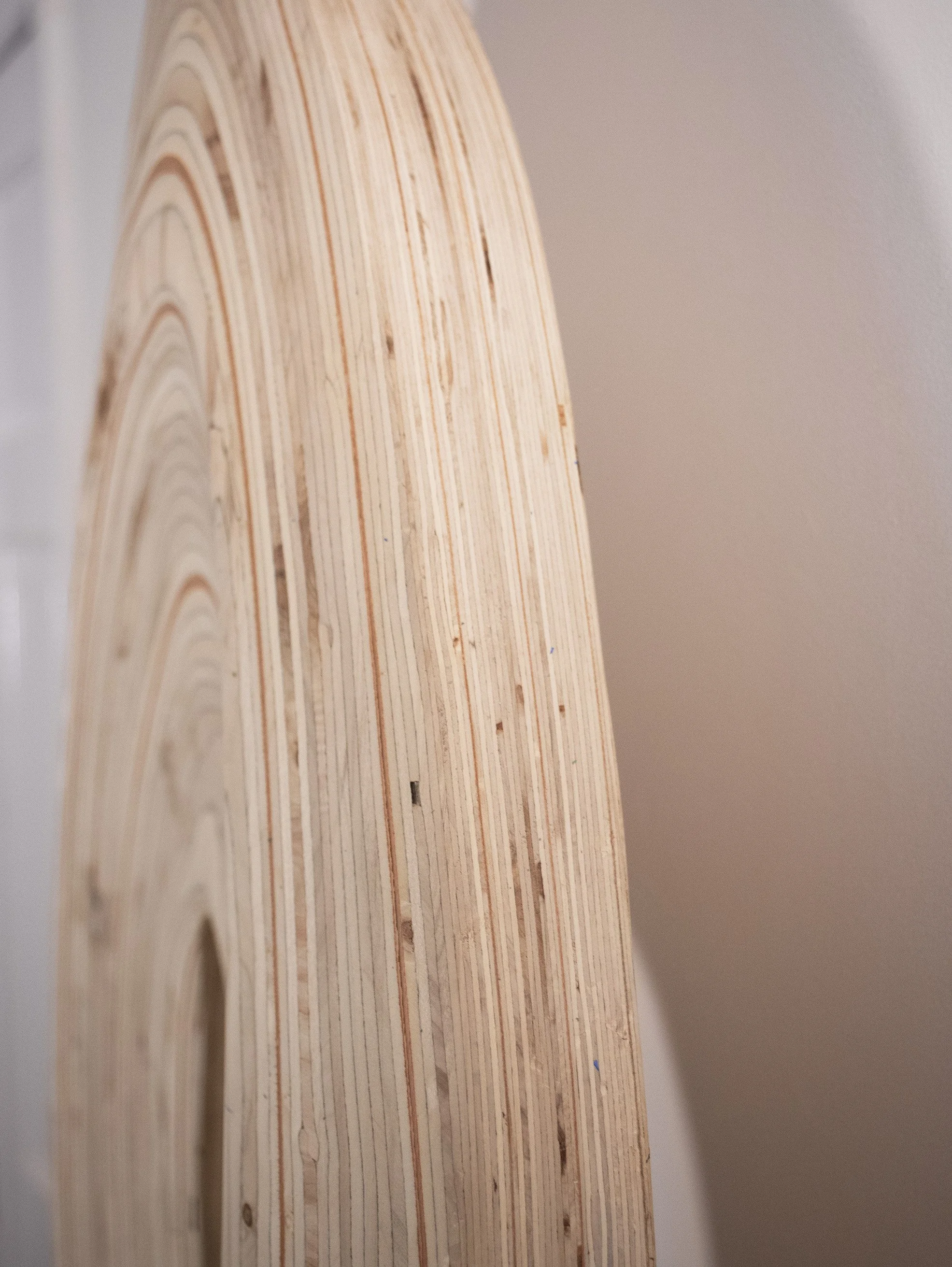Close-up of a wooden surface with a series of carved arches or decorative patterns.