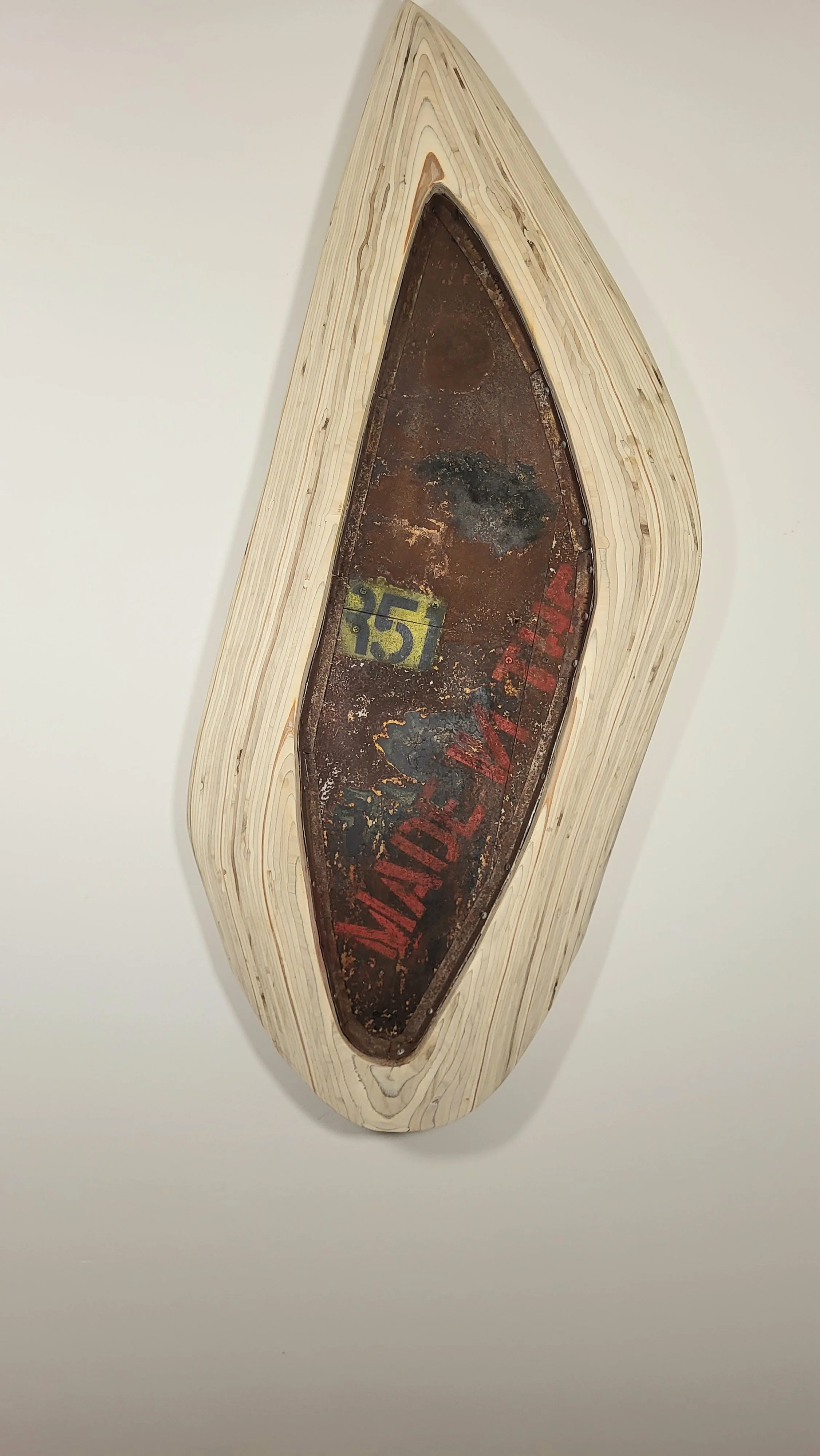 A vintage metal sign reading 'Warning' in red and '15' in yellow, set in a carved wooden frame, with signs of rust and wear.