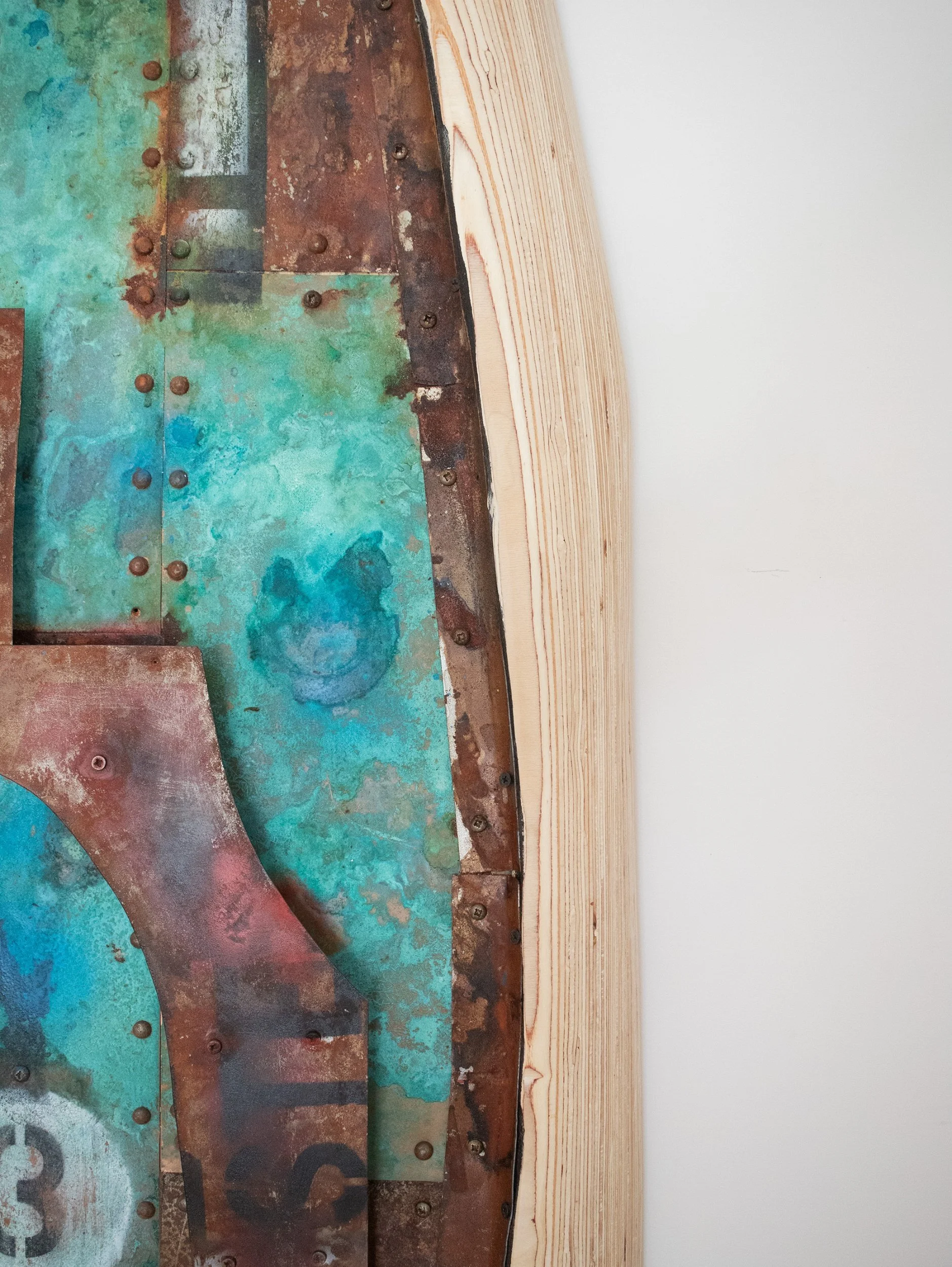 Close-up of a rusted metal surface with rivets, next to a section of light-colored wood with visible grain, and a white background.