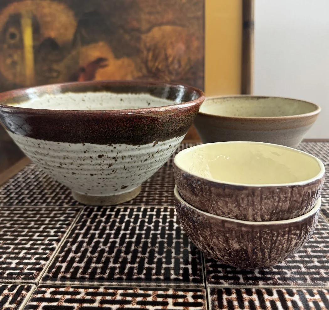 Collection of handcrafted ceramic bowls in brown tones