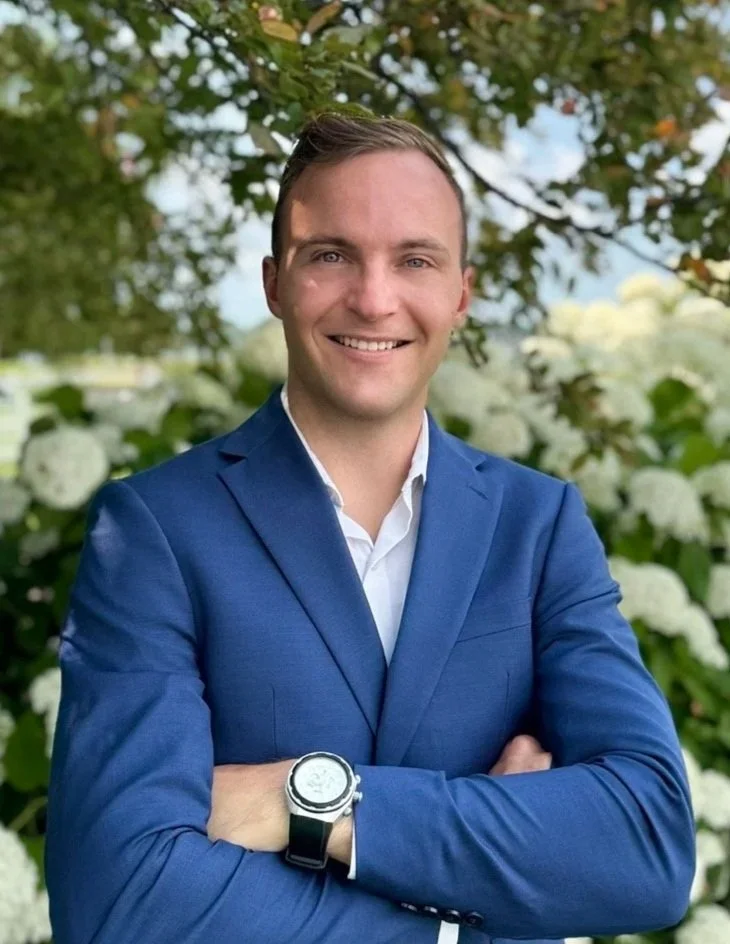 Black silhouette of a person with arms crossed against a white background.