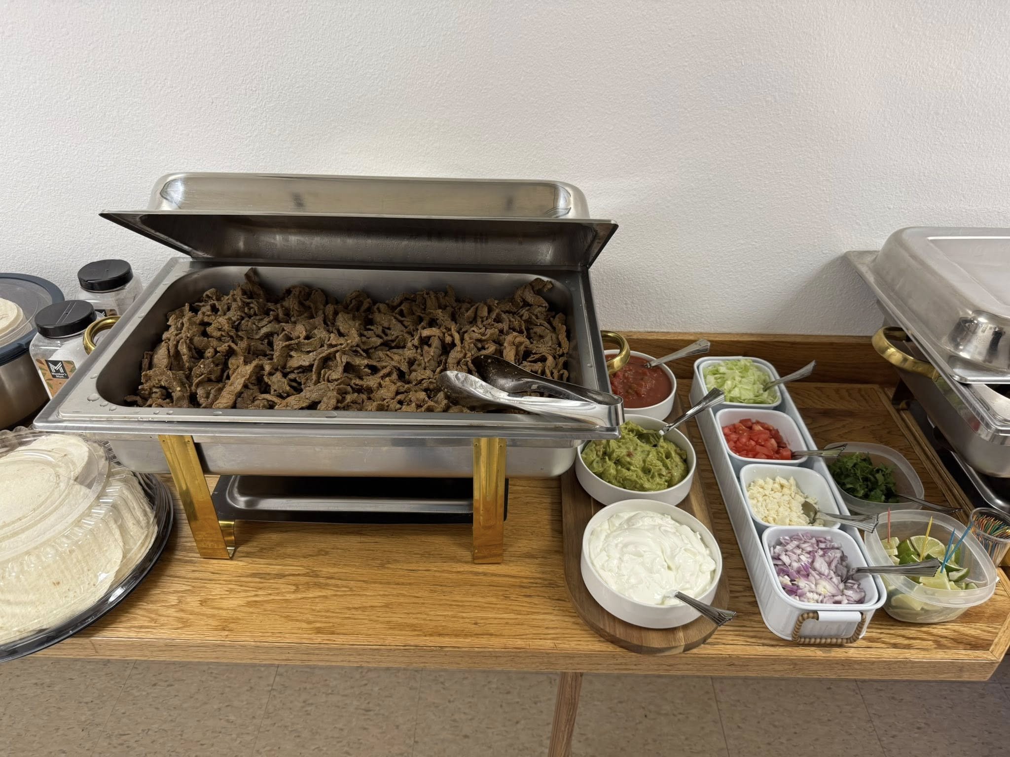 Our homemade carne asada, chili sauce, salsa, guacamole, sour cream, chopped onions, lettuce, cheese, and lemon wedges.